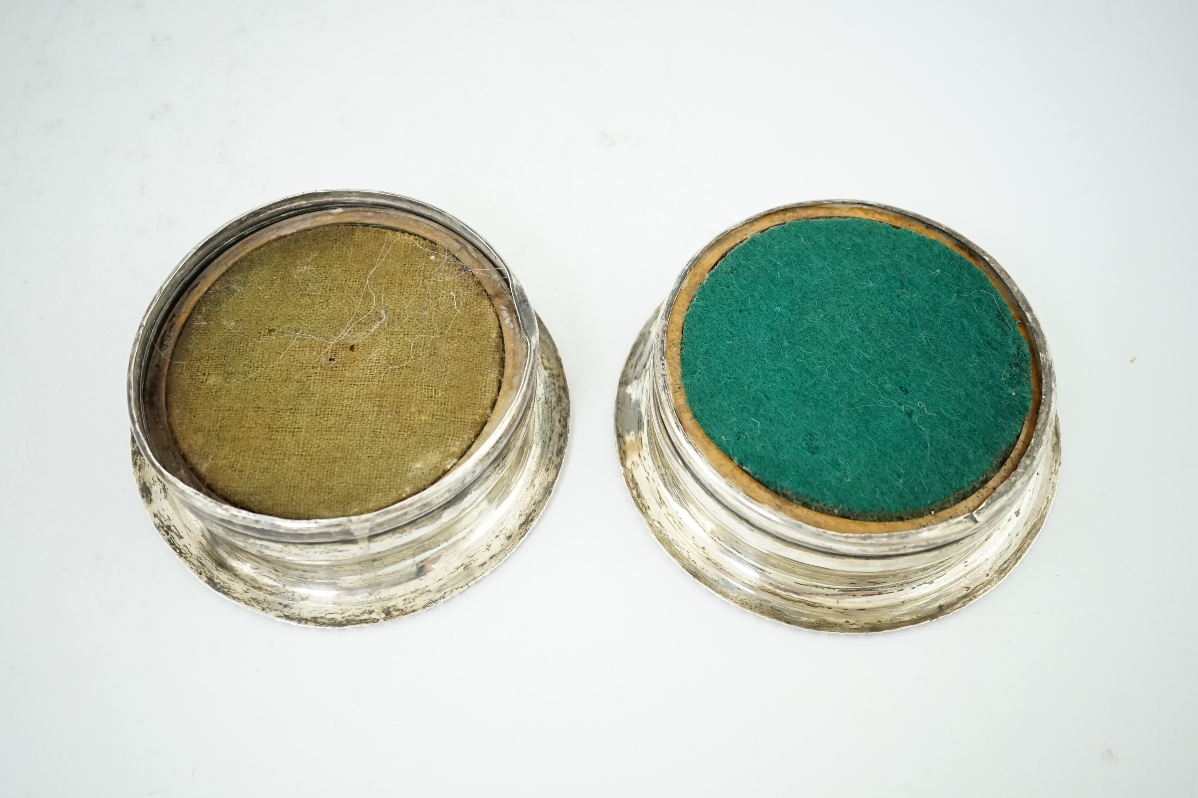 A pair of George III silver wine coasters, by John Roberts & Co, with gadrooned borders and turned wooden bases, Sheffield, 1810, diameter 15.9cm. Condition - poor